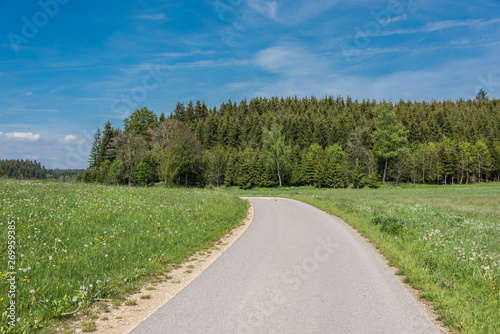 Beautiful road in the nature. Blue sky and green meadows beautiful surroundings to make a trip by car on the road © kugelwolf