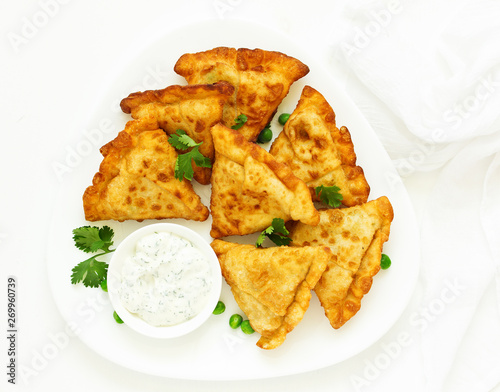 Asian food. Vegetarian samsa (samosas) with tomato sauce