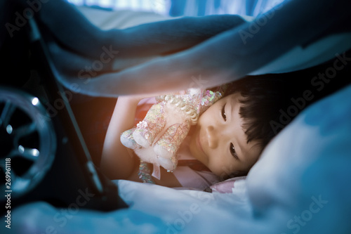 asian Chinese girl playing smartphone on bed, watching smartphone, kid use phone and play game, child use mobile, addicted game and cartoon