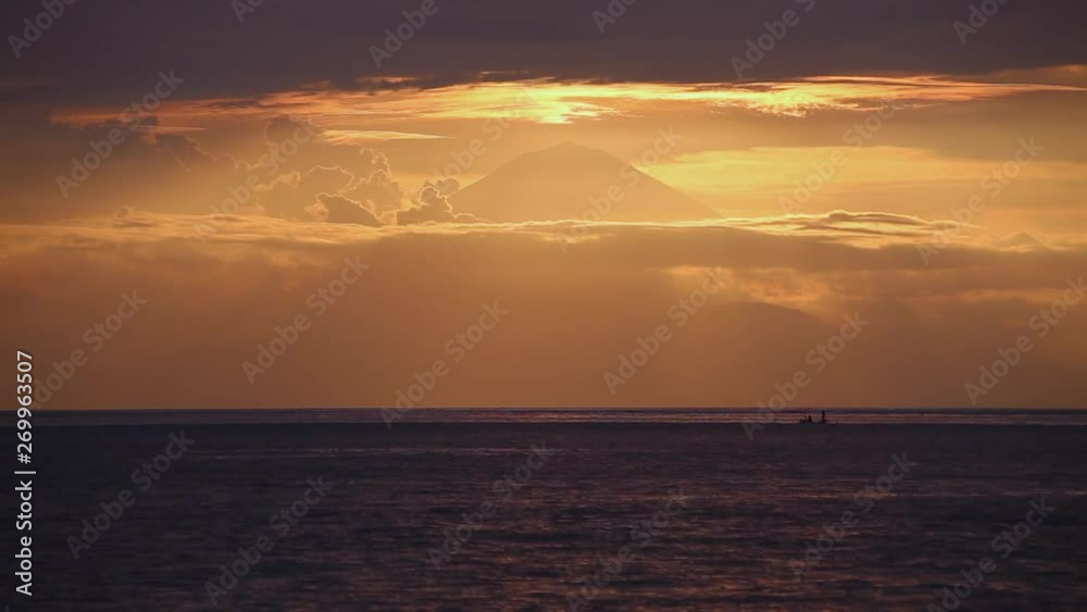 boat anchors in front of the volcano at sunset boat anchors in front of the volcano at sunset