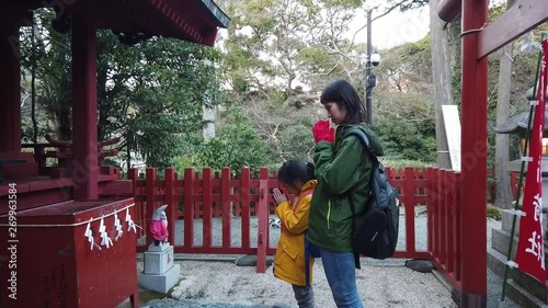 Tokyo, Japan: 21 March 2019: Mother and Daughter is praying in Kamakura shrine.
