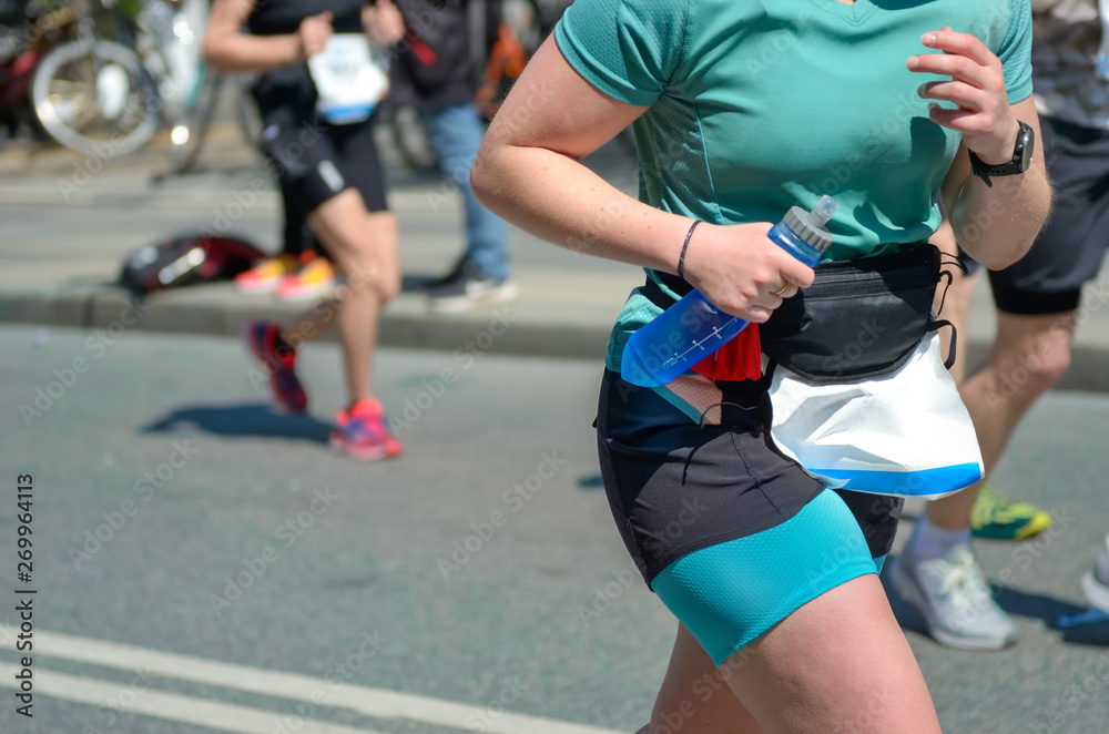 Fototapeta premium Marathon running race, woman runner on road racing, sport competition, fitness and healthy lifestyle concept