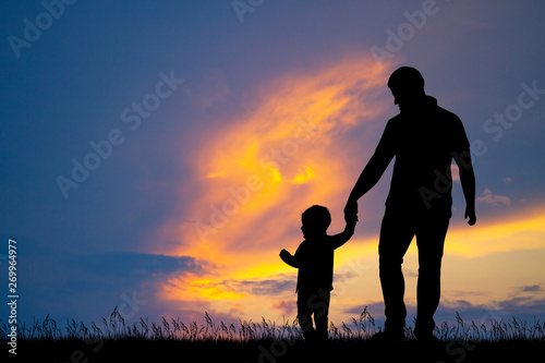 dad with his son at sunset
