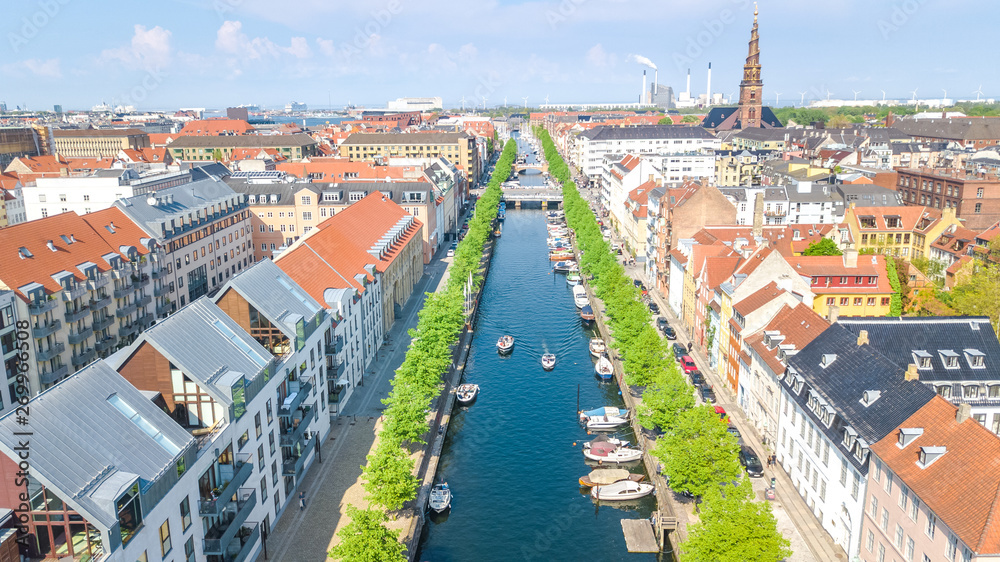 Beautiful aerial view of Copenhagen skyline from above, Nyhavn historical pier port and canal with color buildings and boats in the old town of Copenhagen, Denmark