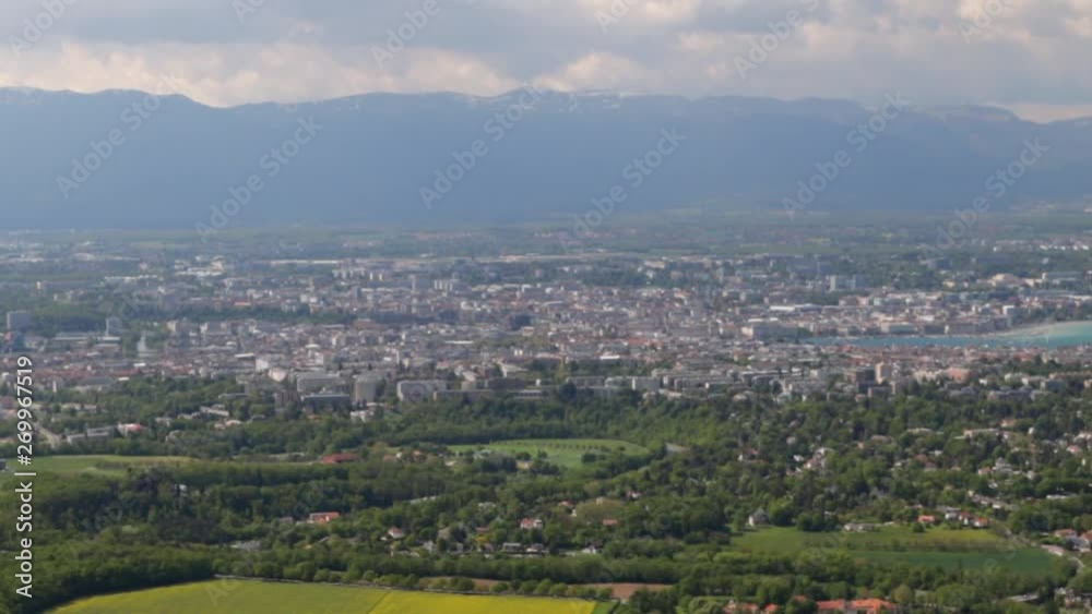 windsock flying on top of the Salève mountain with Geneva in the background down in the valley with clouds and sunrays, panning wide shot windsock flying on top of the Salève mountain with Geneva in the background down in the valley with clouds and sunrays, panning wide shot