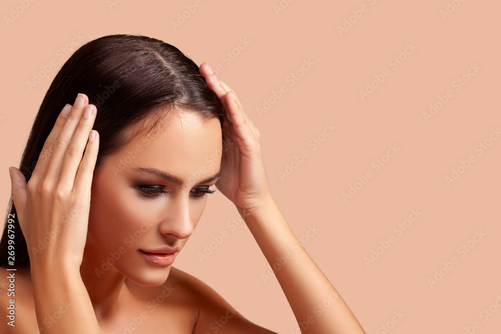 Young woman with hair loss problem on peach background. closeup. free space for advertising. isolated. - Image Young woman with hair loss problem on peach background. closeup. free space for advertising. isolated. - Image