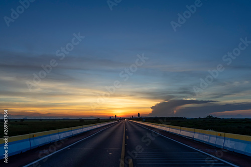 Twilight sky with silhouette of the road.