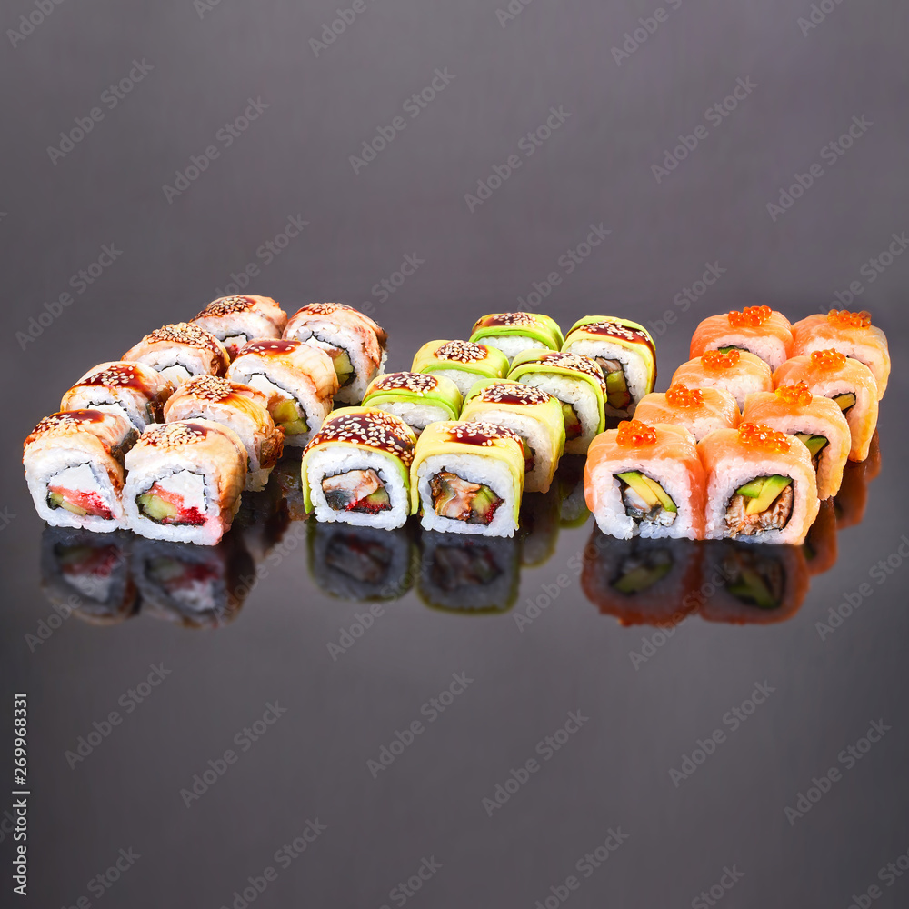 Various kinds of tasty sushi roll on black background for menu. Japanese food Various kinds of tasty sushi roll on black background for menu. Japanese food