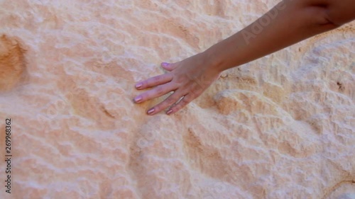 Detail of a woman hand caressing the falesias in Canoa Quebrada photo