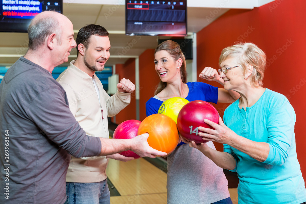 Fototapeta premium Happy family holding bowling ball