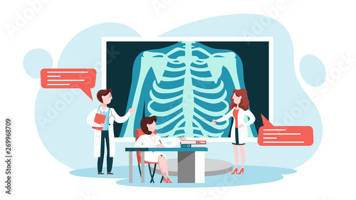 Doctor standing around a big x-ray image of chest