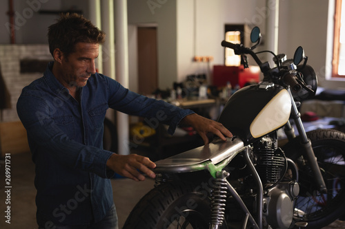Bike mechanic fixing new seat in motorbike 