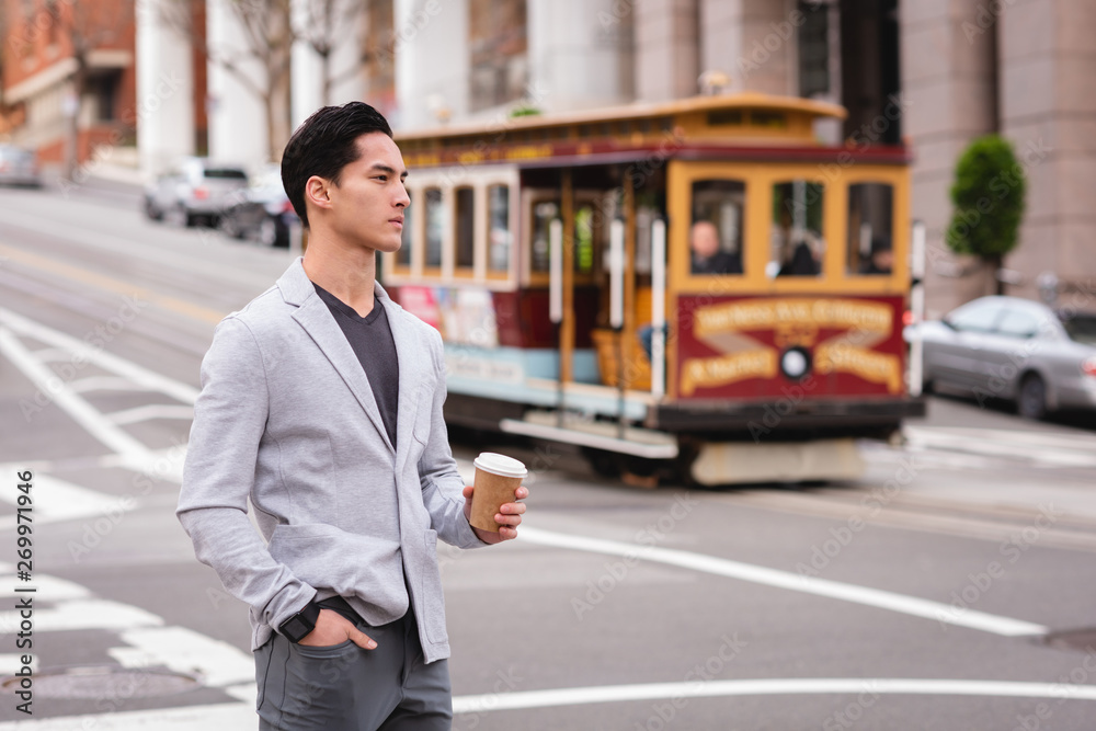 Man standing on street while having coffee Man standing on street while having coffee