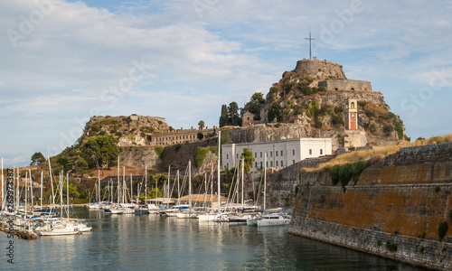 View during the sunset of the old Venetian fortress in Corfu Town and a marina in front of it. 