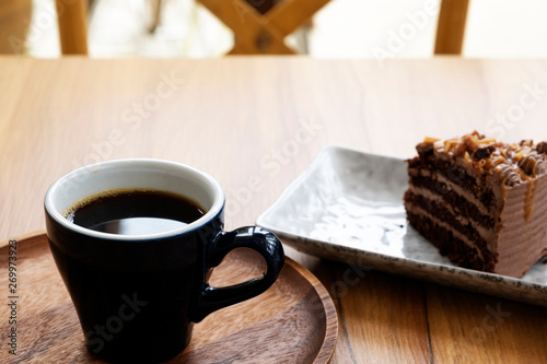 Hot coffee and toffee cake on a wooden table