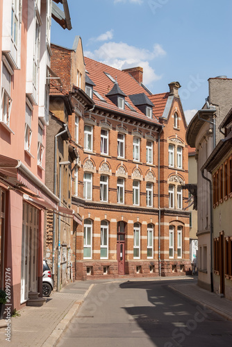 Quiet narrow street with a beautiful brick house in the central part of Erfurt city, Germany. 