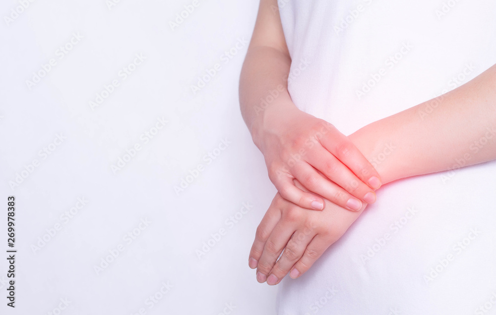 Pain and inflammation in the hand on the wrist of a girl, carpus, tendonitis and podagra, white background, copy space