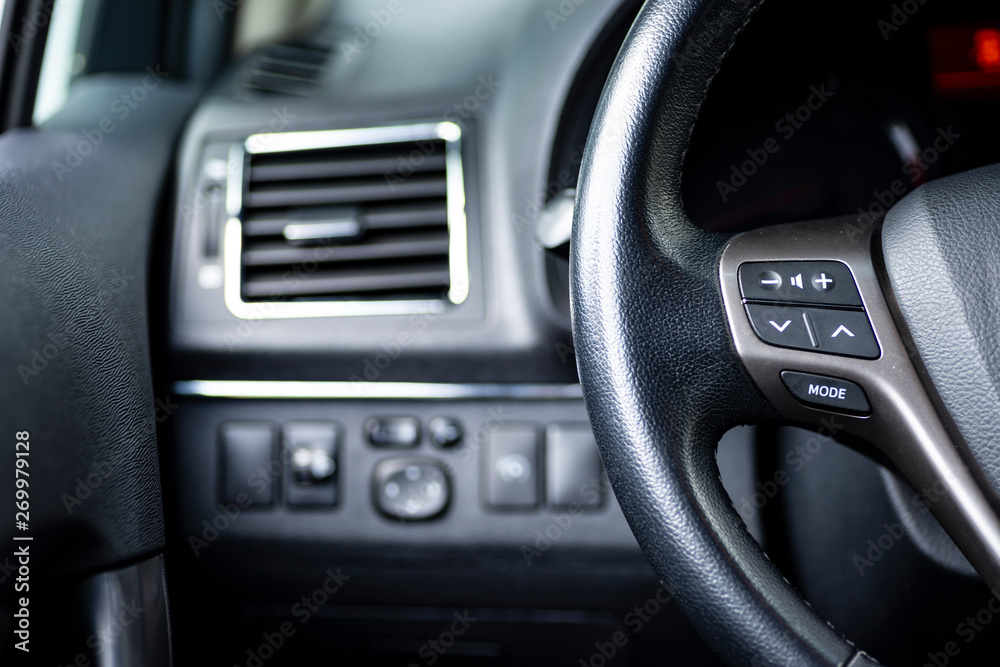 interior of a car, stearing wheel and buttons