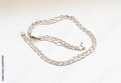 Silver chain located on a white background © YURY