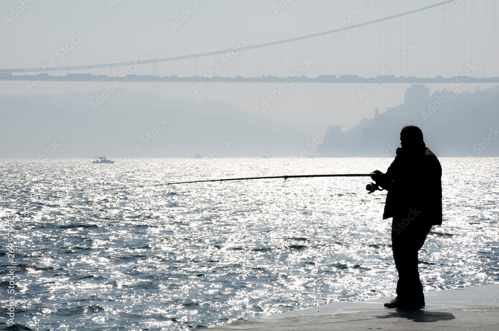 The man fishing in Istanbul in the bridge view. The man fishing in Istanbul in the bridge view.