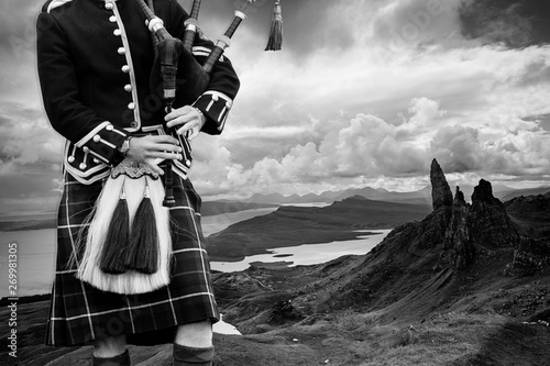 Traditional scottish bagpiper in full dress photo
