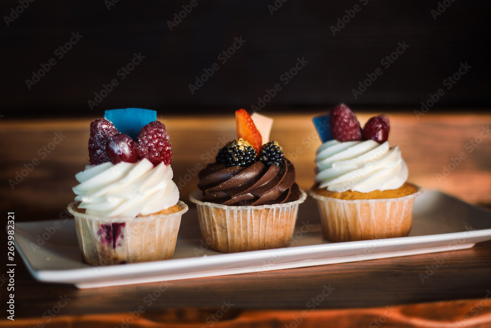 Cupcake with chocolate and butter cream. And also delicious berries.