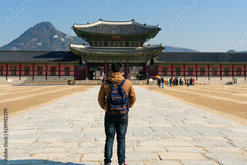 Photography Young asian man traveler traveling to visit Gyeongbok Palace  at Korea, Seoul, South Korea