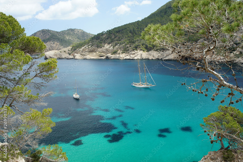 Landscapes of Ibiza.Yachts in the clear water of the Mediterranean.