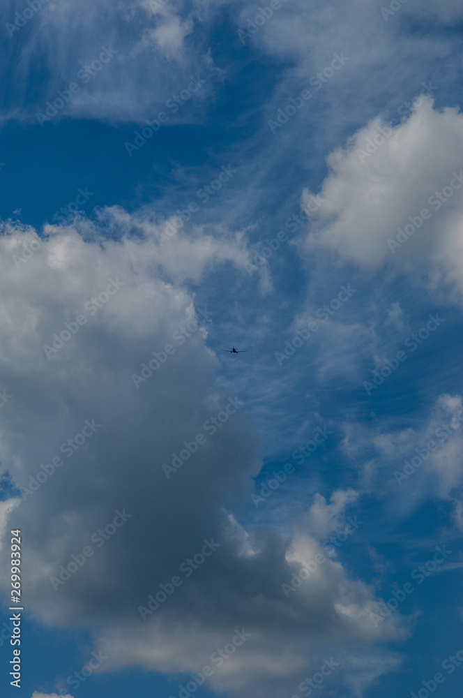 Fototapeta premium light aircraft against the sky with clouds