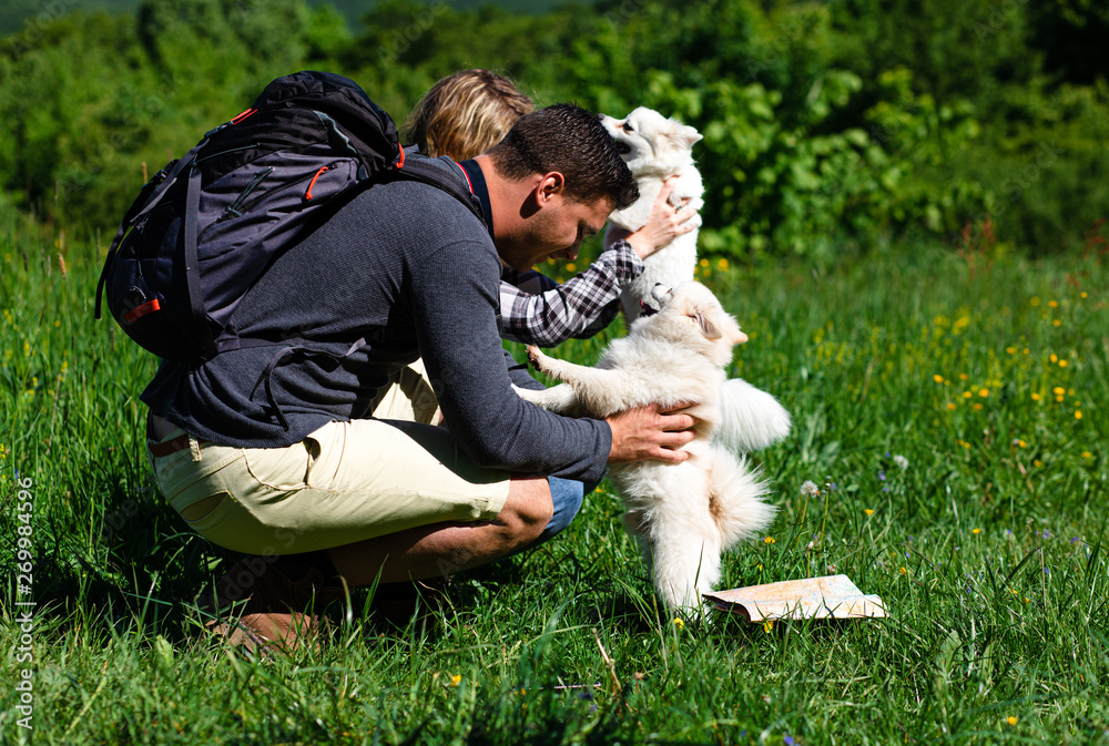 Young couple enjoying hiking together in nature with they dogs. Young couple enjoying hiking together in nature with they dogs.