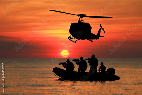  Navy seal silhouettes  on sunrise 
