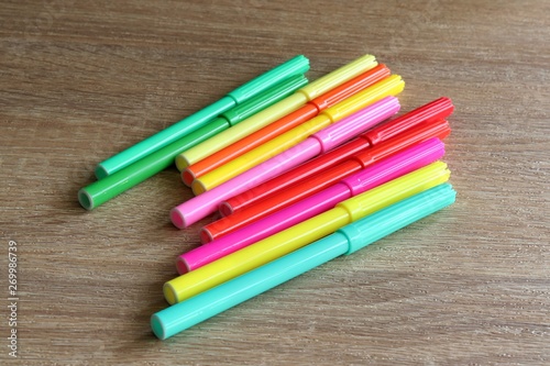 Colourful sketch pens, colour pens against wooden background