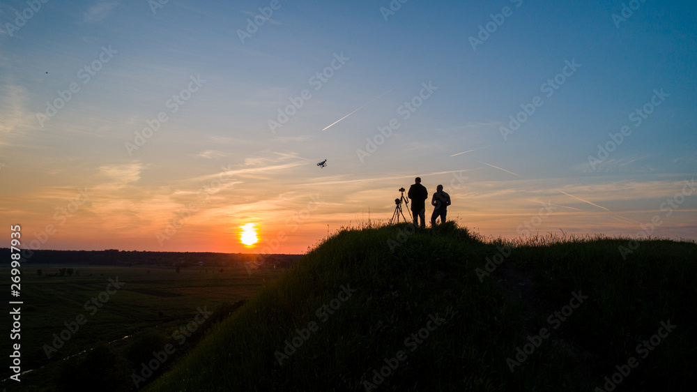 Photographers shoot sunset. Air view