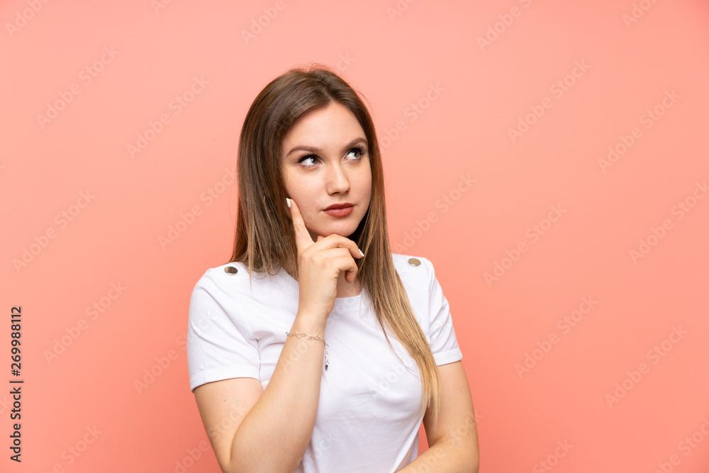 Teenager girl over isolated pink wall thinking an idea Teenager girl over isolated pink wall thinking an idea