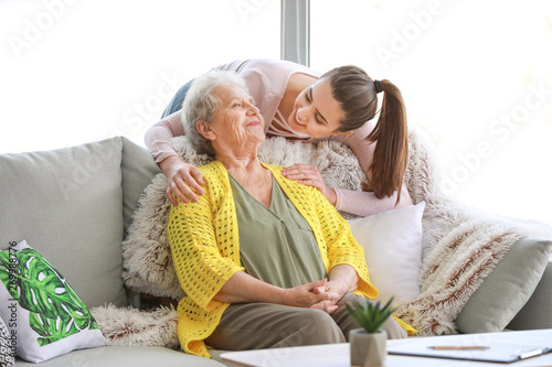 Caregiver with senior woman in nursing home