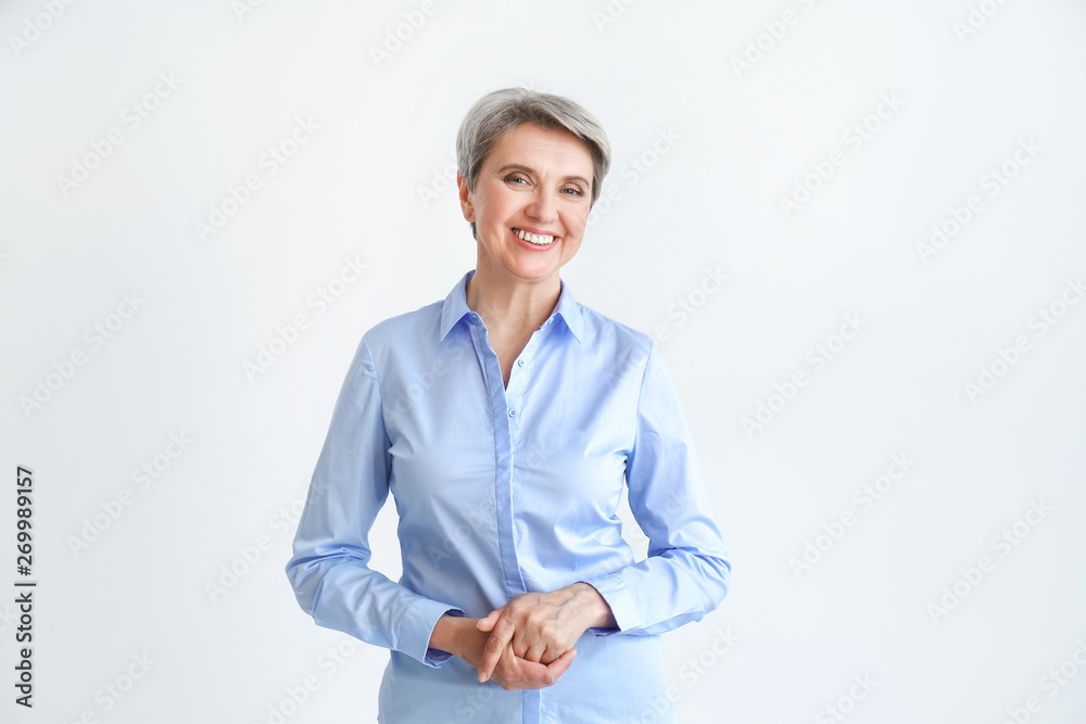 Portrait of stylish mature woman on light background Portrait of stylish mature woman on light background
