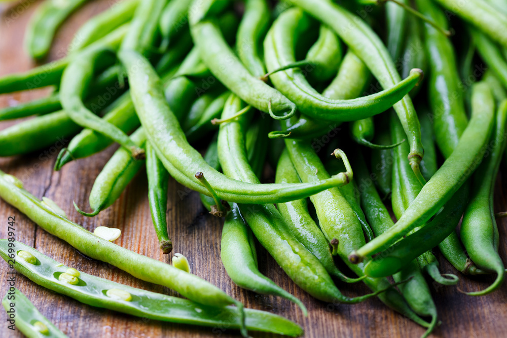 Green beans on wooden cutting board. Go green concept. Close up. Green beans on wooden cutting board. Go green concept. Close up.