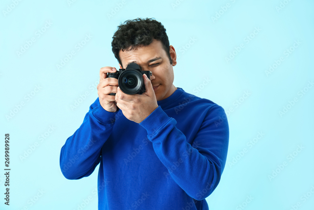 Handsome male photographer on color background Handsome male photographer on color background