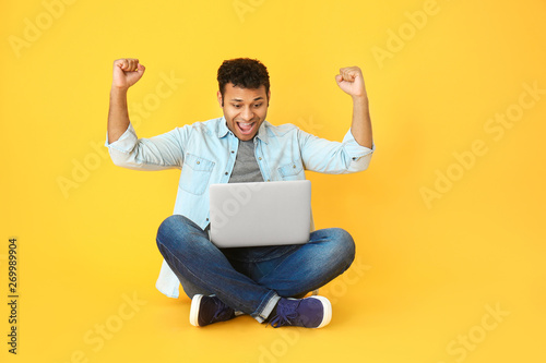 Happy man with laptop on co...