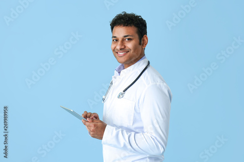 Handsome doctor with tablet...