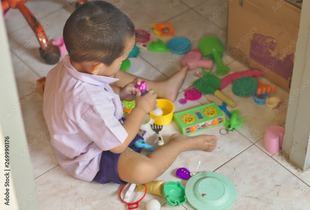 Kindergarten children in school uniforms and toys paid around colorful toys Kindergarten children in school uniforms and toys paid around colorful toys