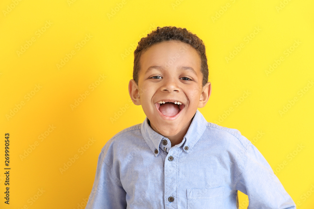 Laughing African-American boy on color background - obrazy, fototapety, plakaty 