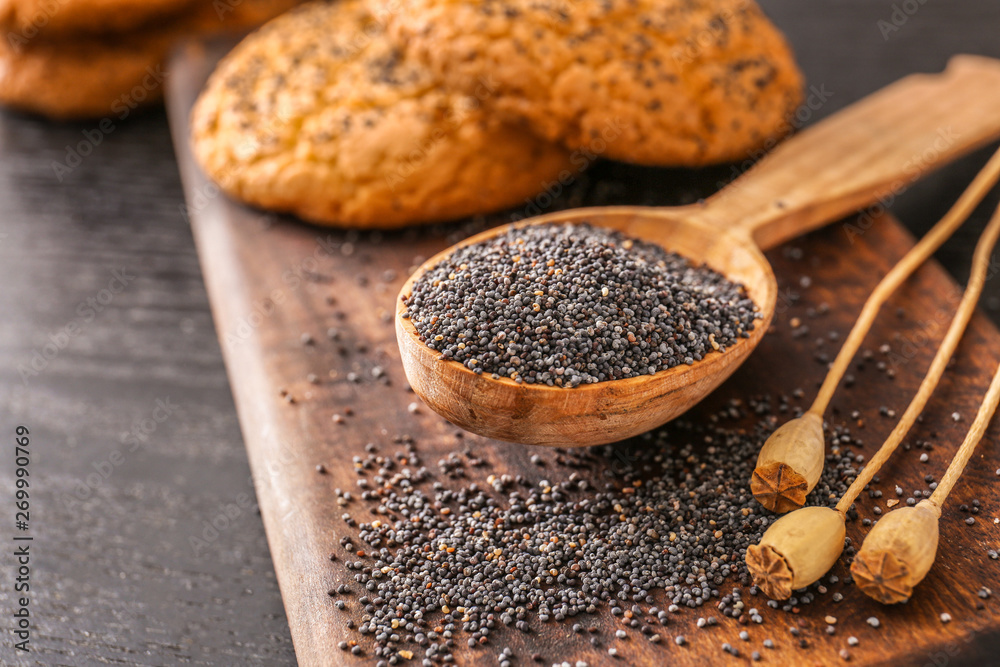 Spoon with poppy seeds on table Spoon with poppy seeds on table