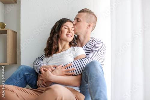 Adorable loving couple resting at home