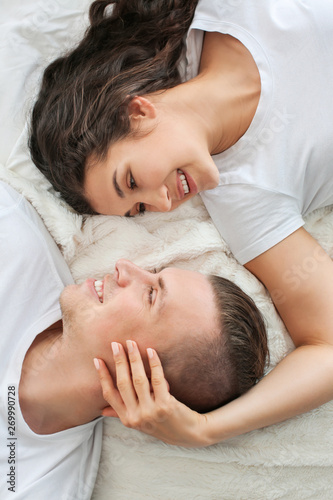 Adorable loving couple lying in bed