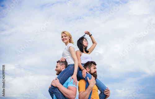 Having a good time together. Loving couples having fun activities outdoor. Loving couples enjoy fun together. Playful couples in love smiling on cloudy sky. Happy men piggybacking their girlfriends