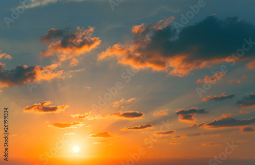 Beautiful view of a sunset sky with sun, sunrays and clouds. Nature summer background. © Androlia
