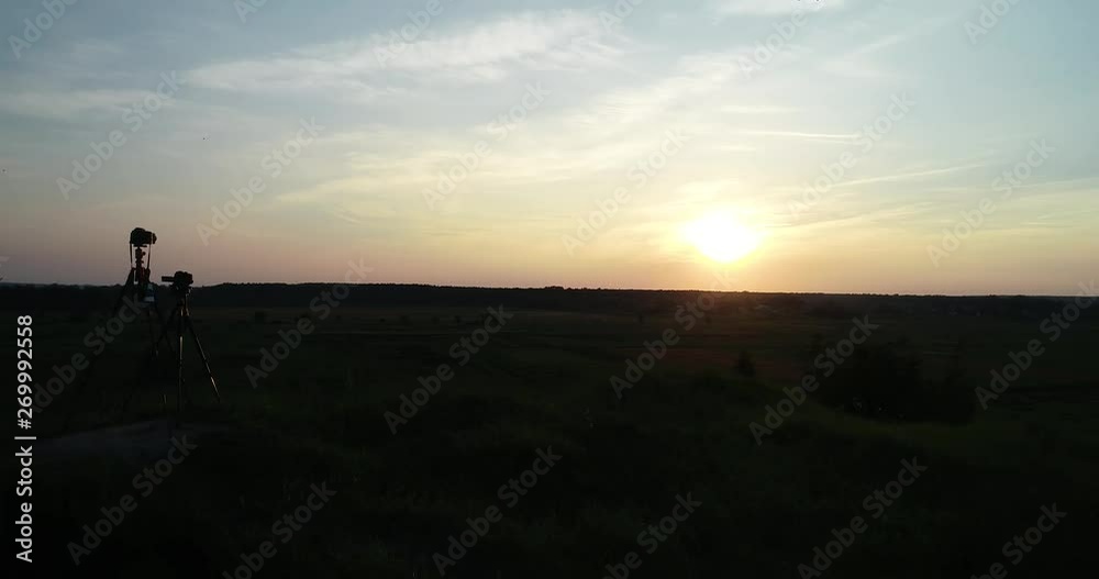 Photographers shoot sunset. Air view Photographers shoot sunset. Air view
