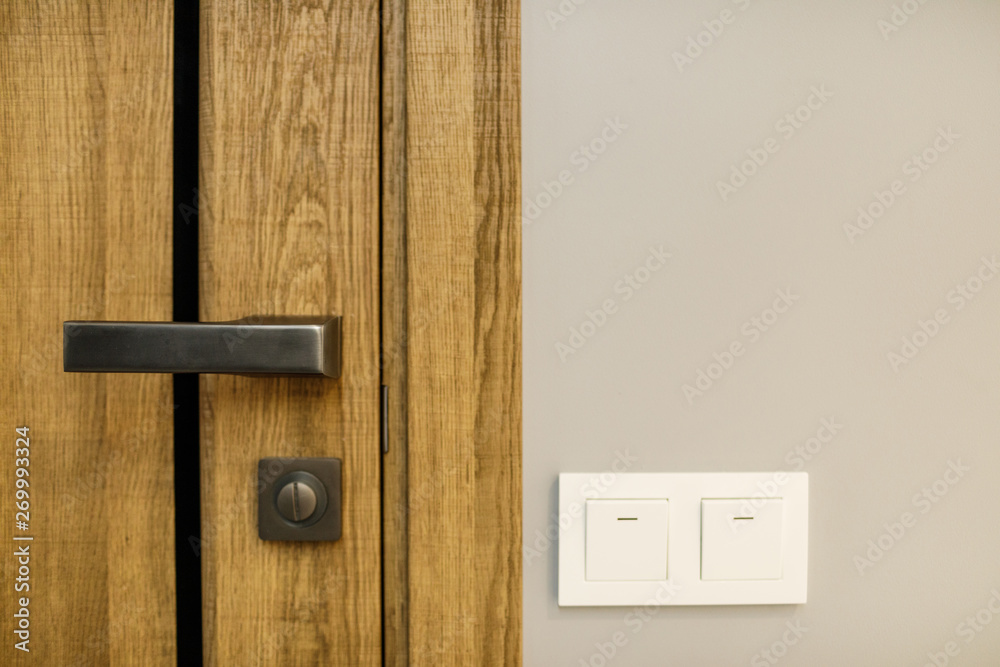 Obraz premium modern style door handle on natural wooden door