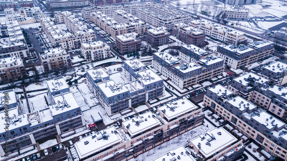 Aerial view of snowed in traditional housing suburbs